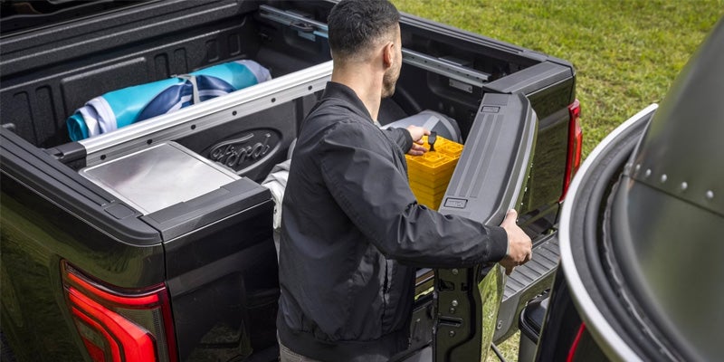 A Man Closing Tailgate Of A F-150 Vehicle