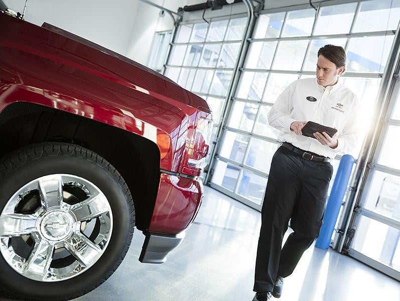 Man Inspecting A Car